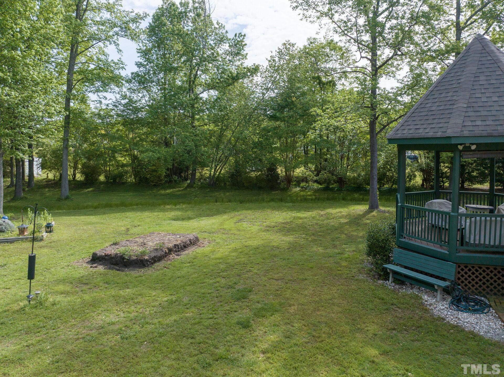 920 Wagstaff Road Fuquay-Varina, NC 27526 - Photo 51 of 58 a backyard of a house with barbeque oven table and chairs