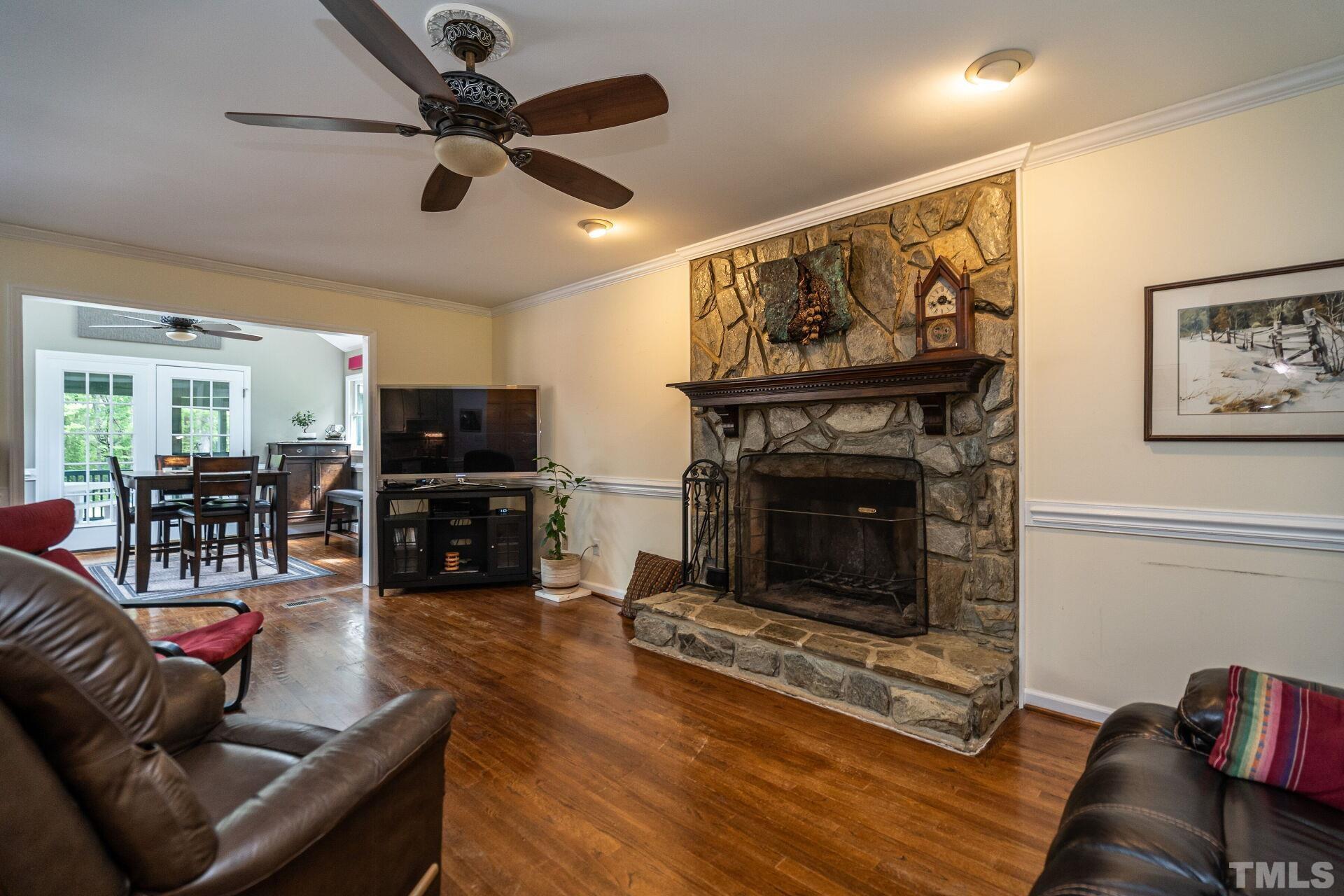 920 Wagstaff Road Fuquay-Varina, NC 27526 - Photo 7 of 58 a living room with furniture a fireplace and a flat screen tv