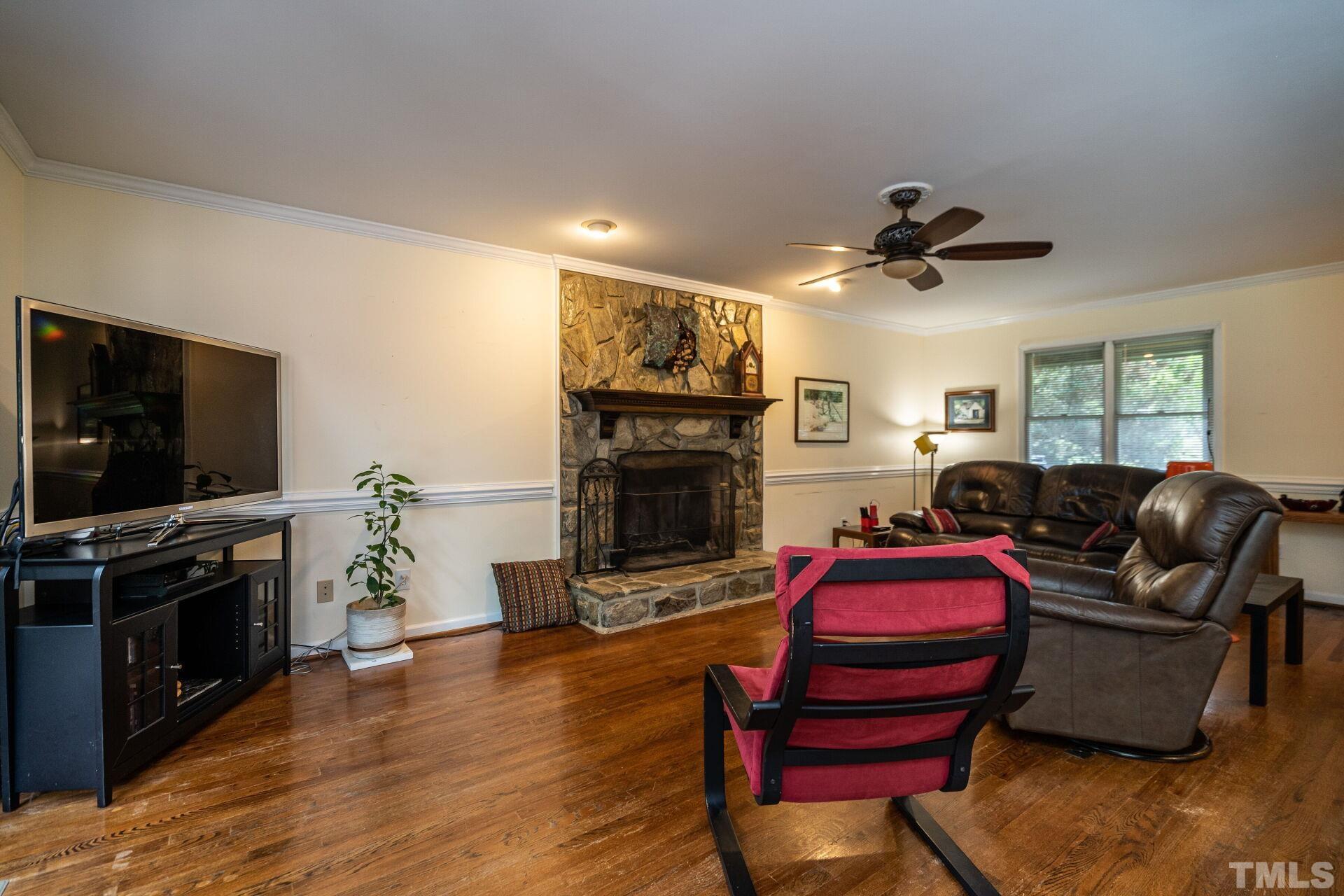 920 Wagstaff Road Fuquay-Varina, NC 27526 - Photo 8 of 58 a living room with furniture a flat screen tv and a fireplace
