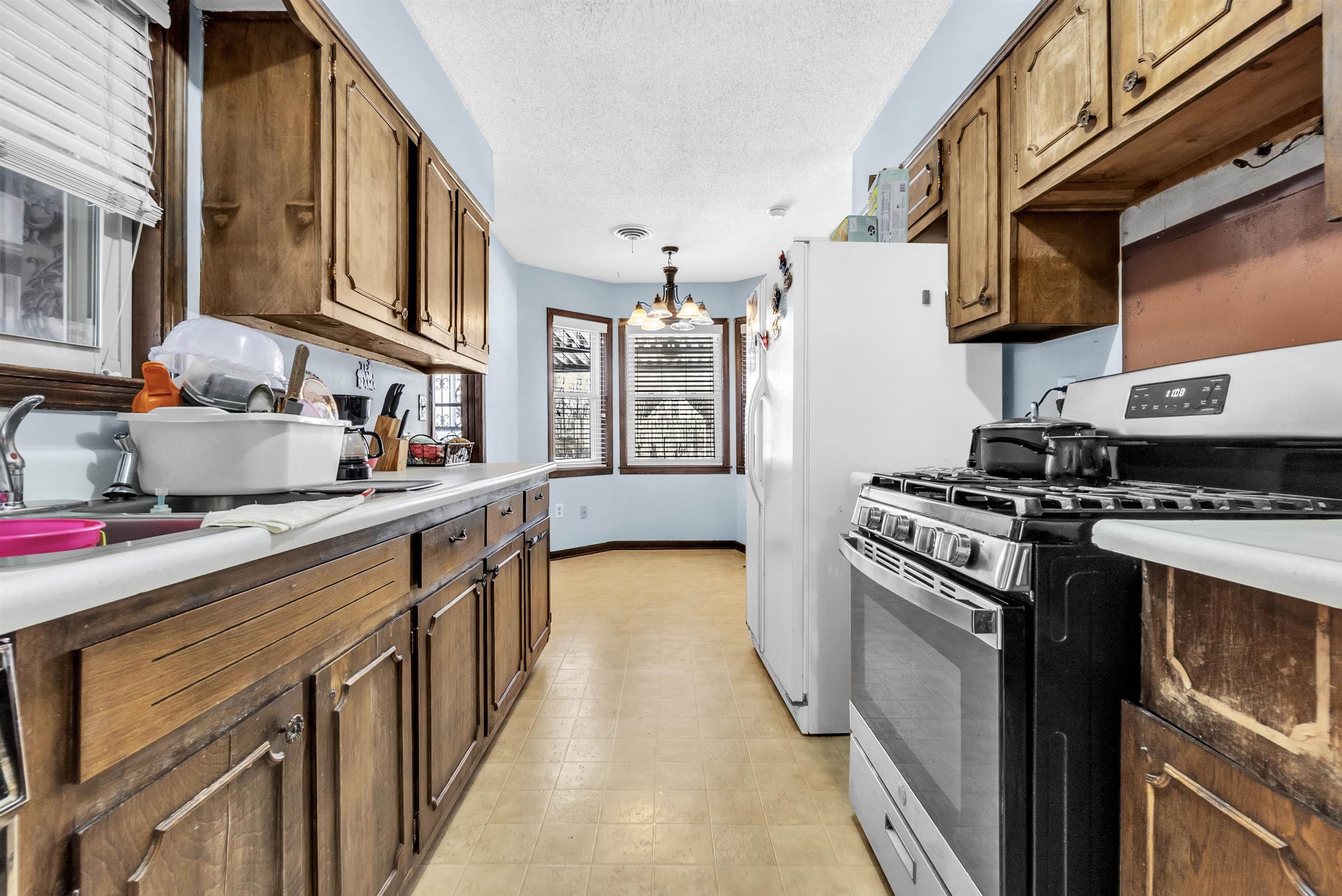 3463 Dupre Street Memphis, TN 38115 - Photo 11 of 25 Kitchen featuring gas range, pendant lighting, a chandelier, a textured ceiling, and light floors