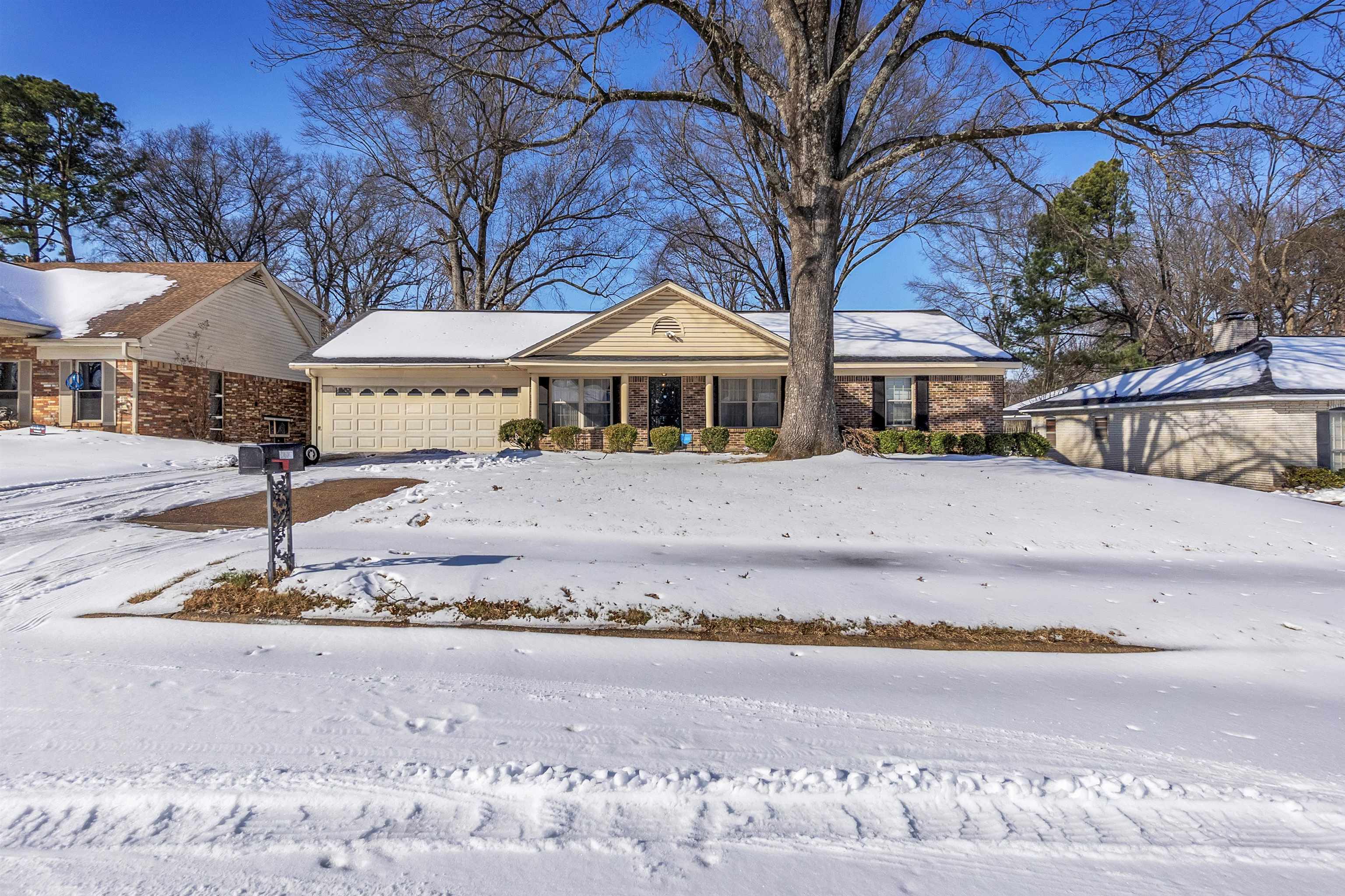 3463 Dupre Street Memphis, TN 38115 - Photo 2 of 25 Ranch-style home featuring brick siding, a garage, and covered porch