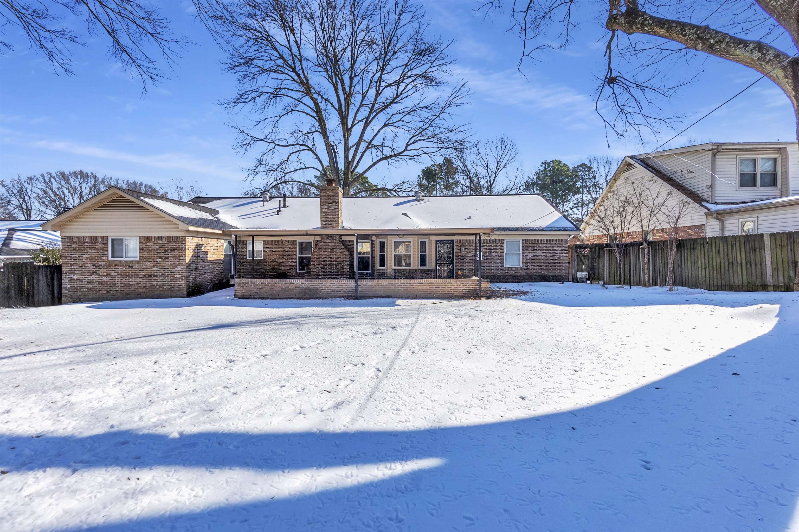 3463 Dupre Street Memphis, TN 38115 - Photo 24 of 25 Snow covered property featuring a chimney and brick siding