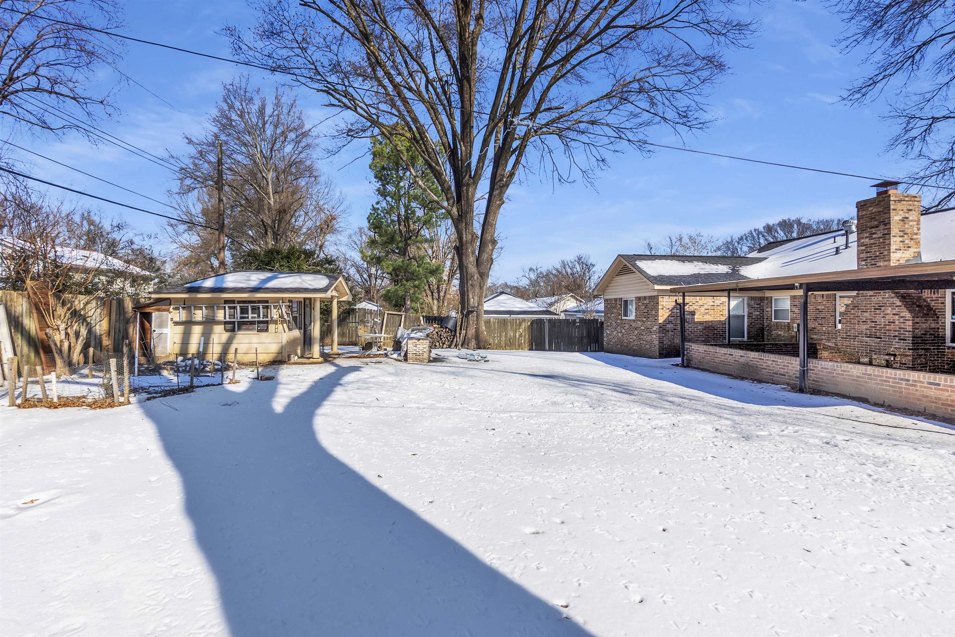 3463 Dupre Street Memphis, TN 38115 - Photo 25 of 25 Snowy yard with an outdoor structure and a fenced backyard