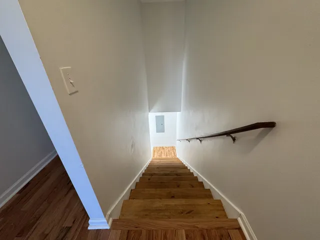 a view of a room with wooden floor