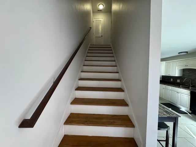 a utility room with cabinets washer and dryer