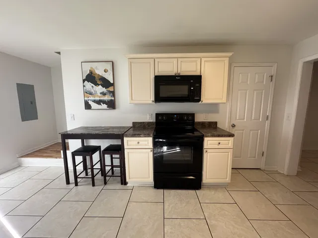 a kitchen with stainless steel appliances granite countertop a refrigerator sink and cabinets