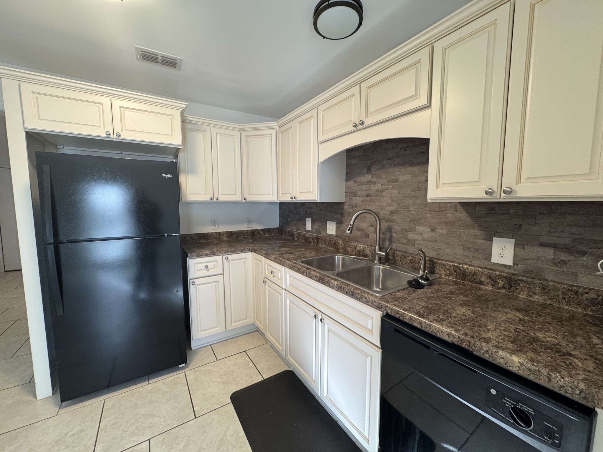 531 Dill Lane, Unit A9 Murfreesboro, TN 37130 - Photo 18 of 24 a kitchen with stainless steel appliances granite countertop a refrigerator sink and cabinets