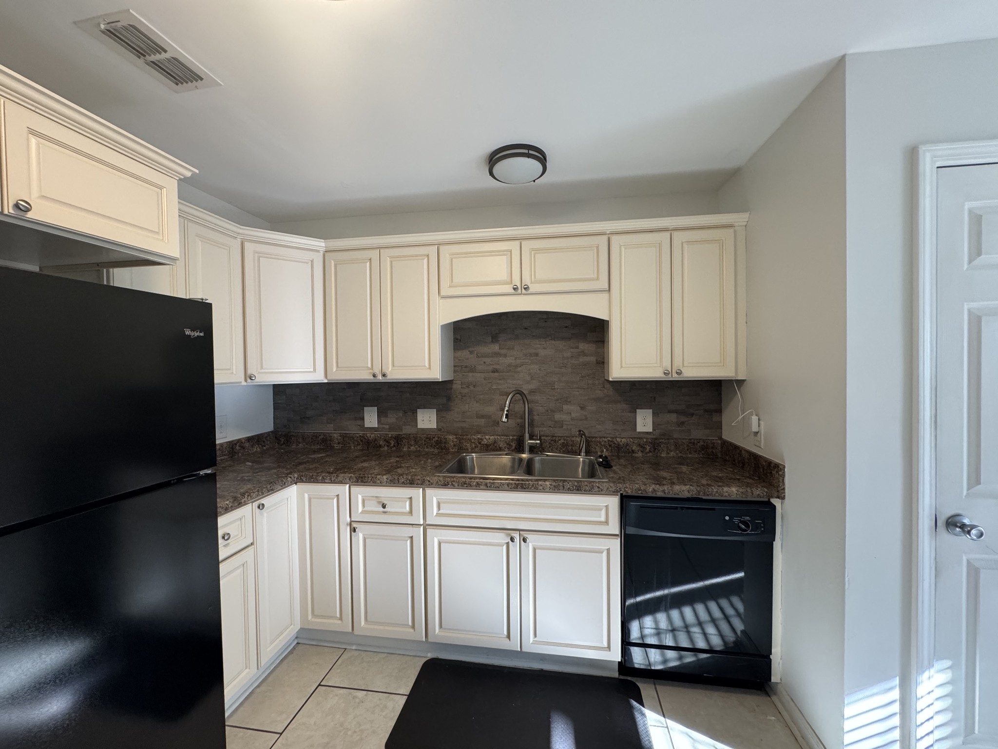 531 Dill Lane, Unit A9 Murfreesboro, TN 37130 - Photo 19 of 24 a kitchen with granite countertop a sink cabinets and stainless steel appliances