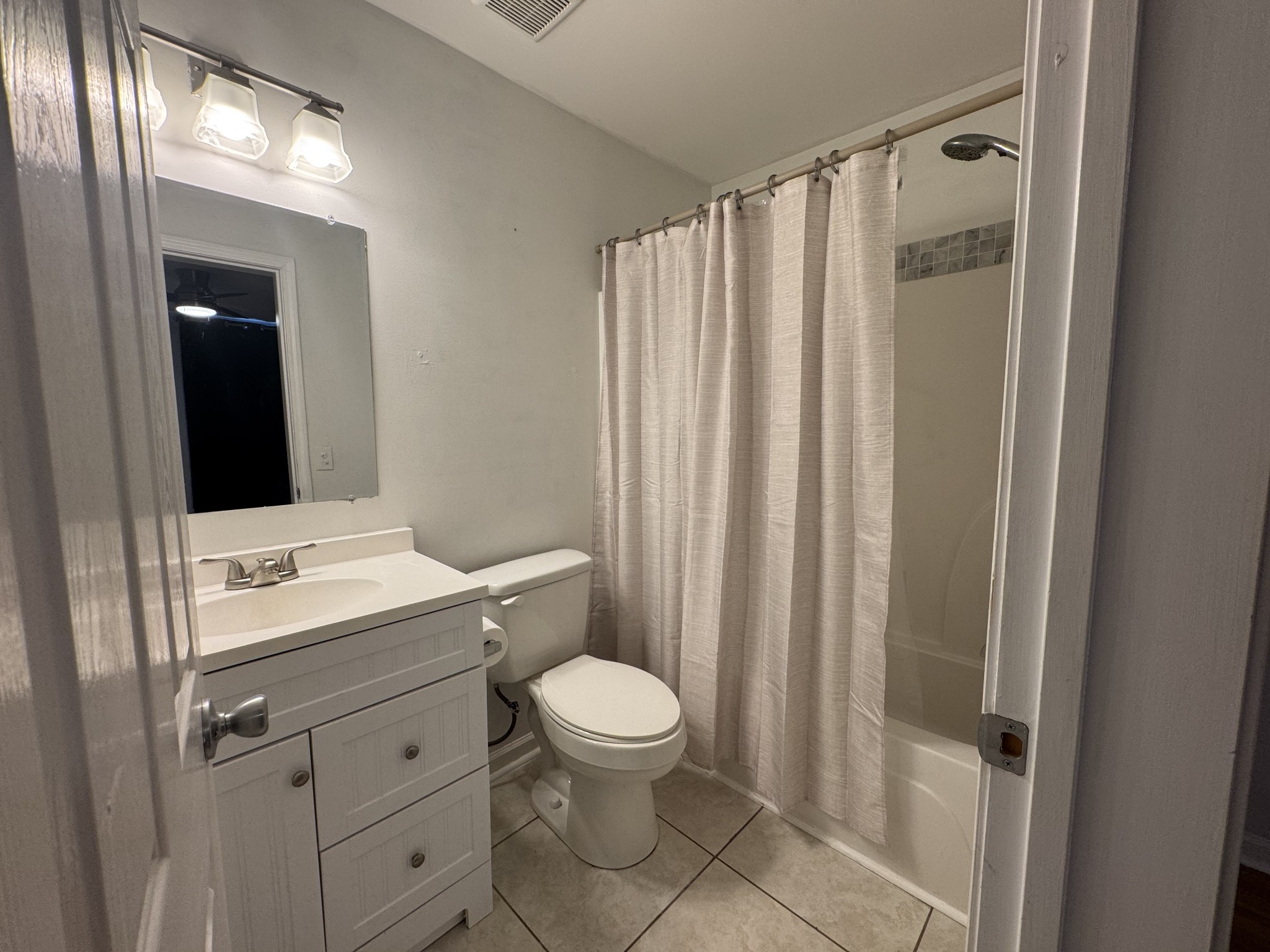 531 Dill Lane, Unit A9 Murfreesboro, TN 37130 - Photo 21 of 24 a bathroom with a sink a toilet a mirror and shower curtain