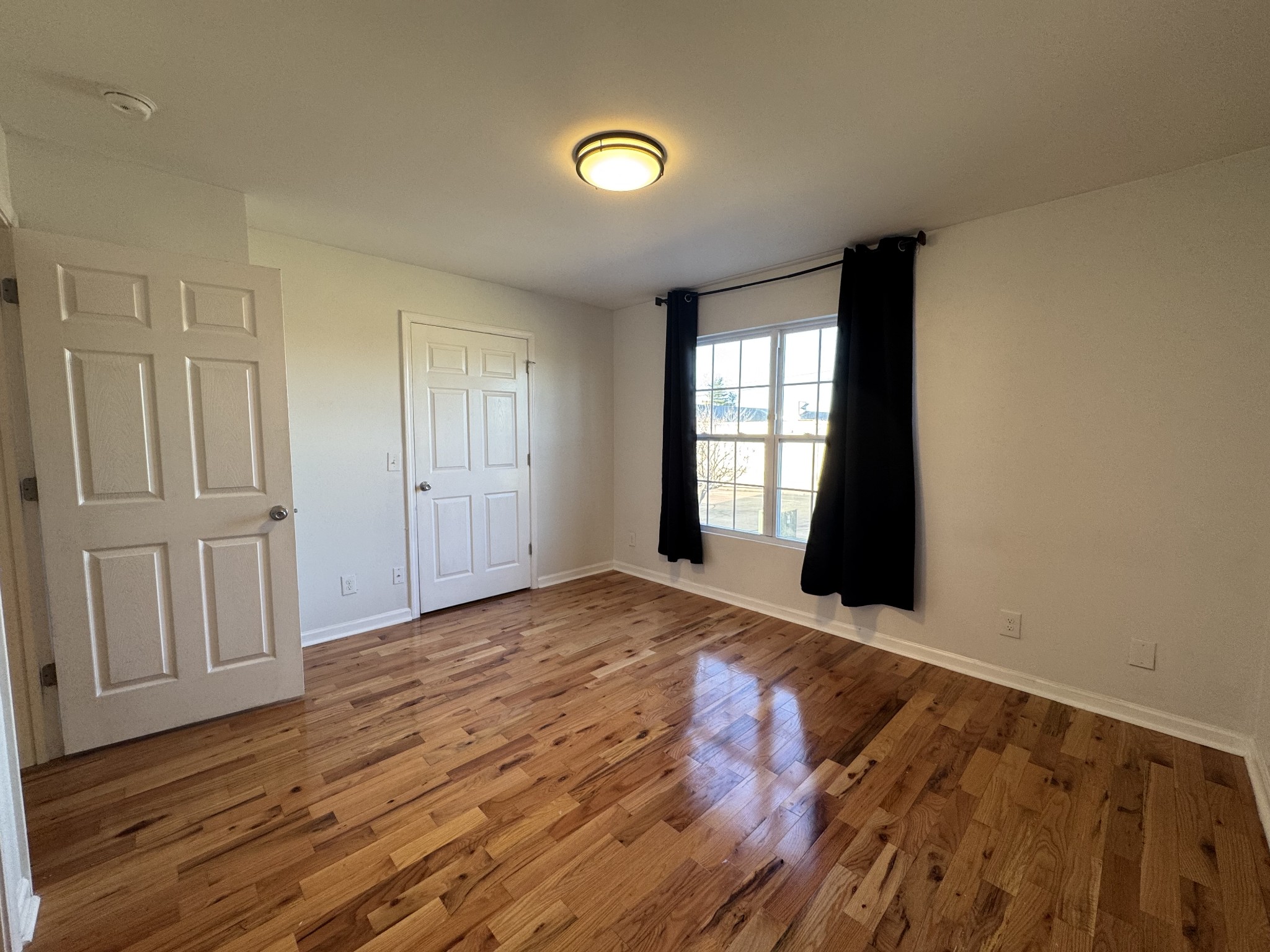 531 Dill Lane, Unit A9 Murfreesboro, TN 37130 - Photo 8 of 24 wooden floor in an empty room with a window