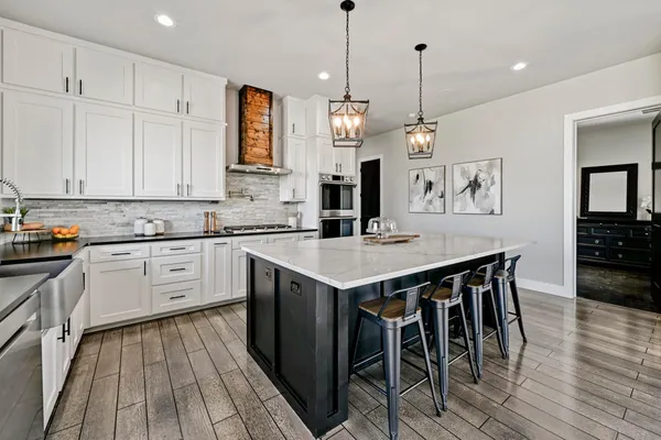 a kitchen with a table chairs sink and cabinets