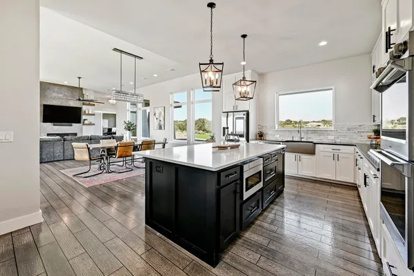 a kitchen with a sink stove and cabinets