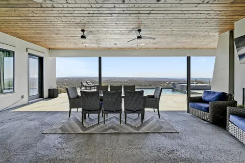 a view of a dinning table and chairs in the patio