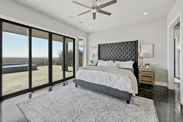 a bedroom with a large bed and a chandelier
