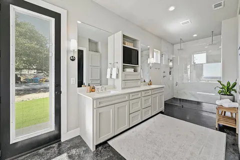 a large bathroom with a granite countertop sink mirror and shower