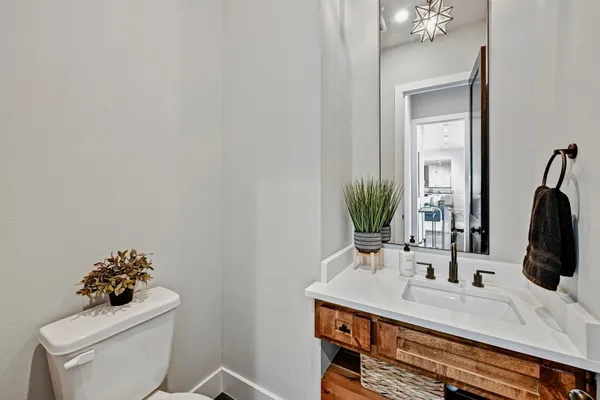 a bathroom with a sink toilet and mirror