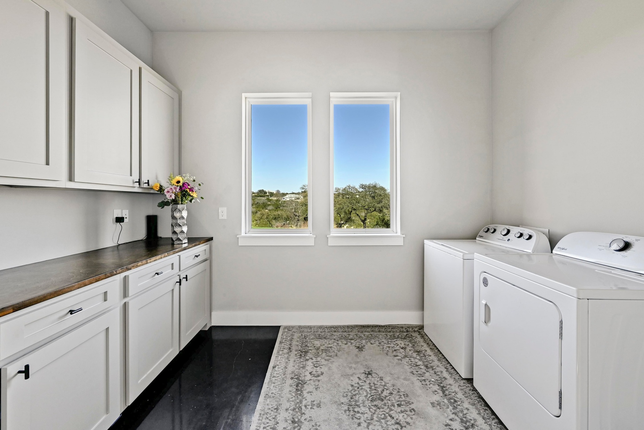 220 Eagle Ridge Burnet, TX 78611 - Photo 28 of 40 The spacious laundry room is thoughtfully designed with ample storage and functionality to simplify everyday living while maintaining the home’s refined aesthetic.