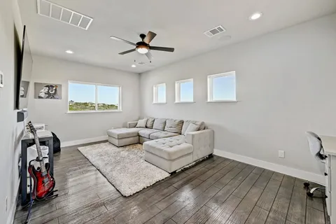 a living room with furniture and wooden floor