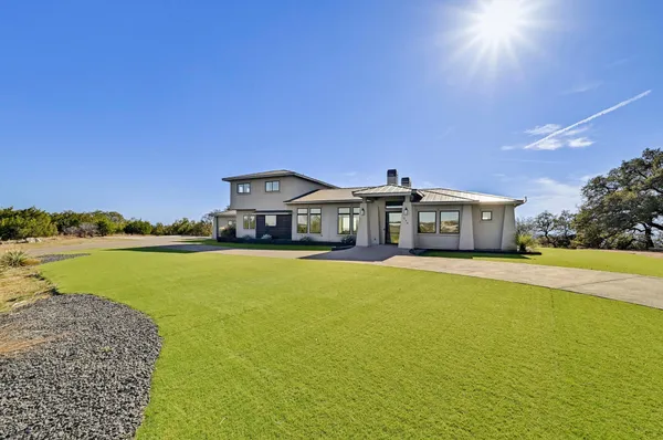 a front view of a house with a big yard