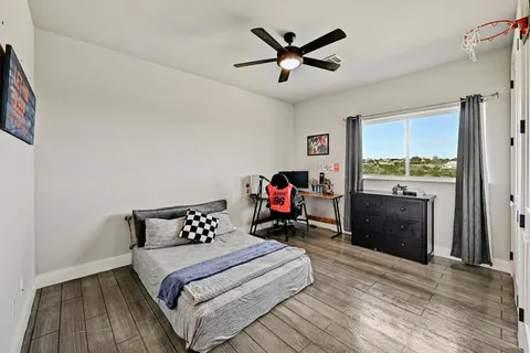 a bedroom with a bed and a chandelier
