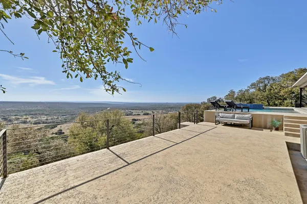a swimming pool with outdoor seating and yard