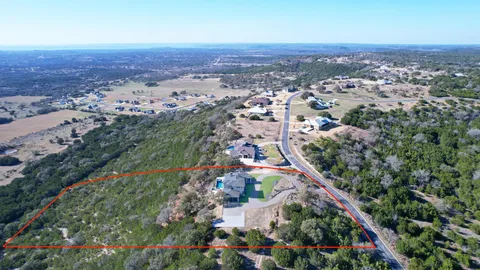 an aerial view of a house with outdoor space