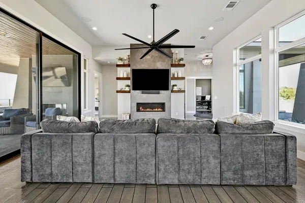 a living room with furniture flat screen tv and a fireplace