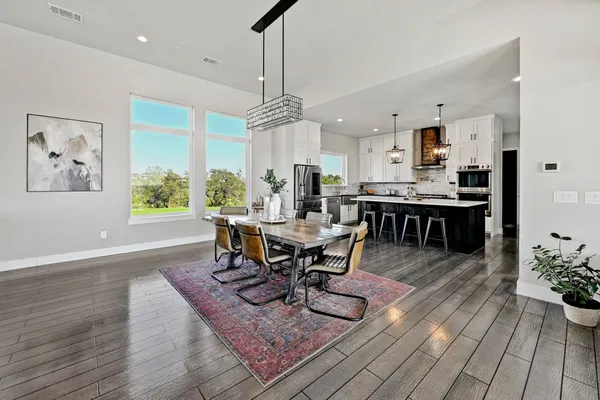 a view of a dining room with furniture window and wooden floor
