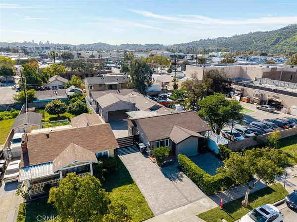 an aerial view of a house with yard swimming pool and mountain view in back