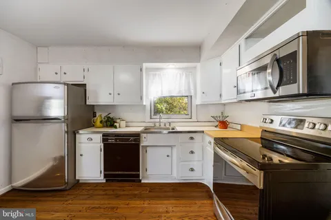 a kitchen with stainless steel appliances granite countertop a stove a sink dishwasher and a refrigerator