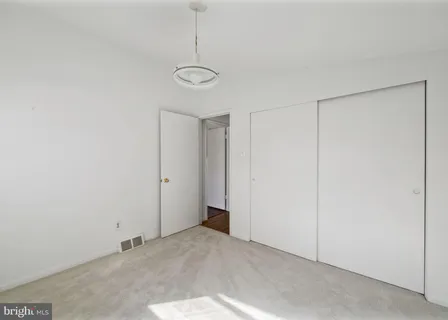 a view of a room with a ceiling fan