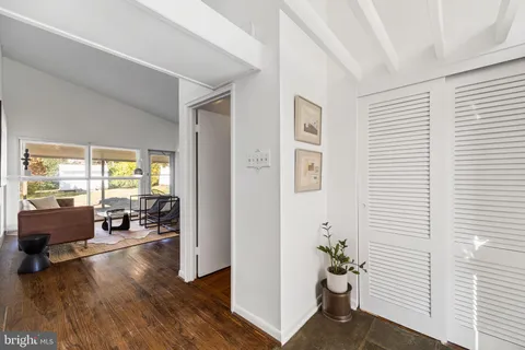 a view of a livingroom with furniture and hardwood floor