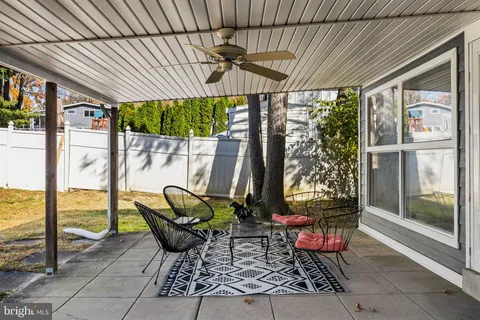 a patio with glass top table and chairs