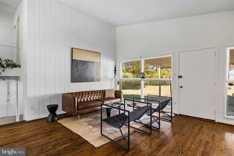 a workspace room with furniture and wooden floor