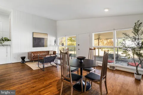 a dining room with furniture and wooden floor