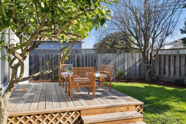 a view of a chairs and table in backyard