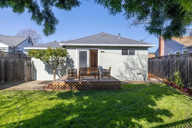 a view of a house with a yard and sitting area