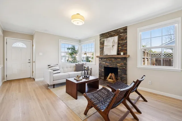 a living room with furniture and a fireplace