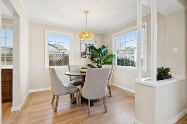 a view of a dining room with furniture window and wooden floor