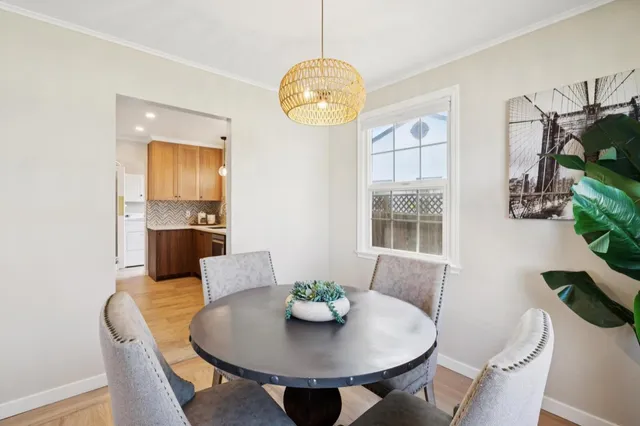 a view of a dining room with furniture and chandelier