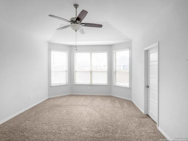 a view of room with a ceiling fan and window