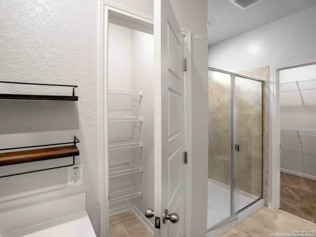 a bathroom with a glass shower door