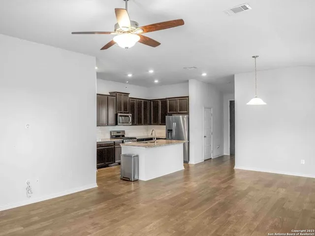 a kitchen with a stove and a refrigerator
