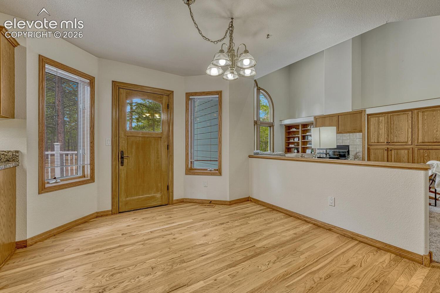 15430 Bar X Road Colorado Springs, CO 80908 - Photo 17 of 50 Dining Nook with access to the backyard deck for outdoor dining and relaxation.