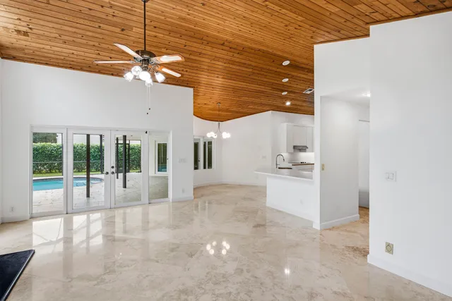 a view of a livingroom with a fireplace furniture and a ceiling fan