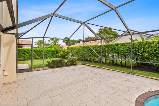 a view of a house with a yard and potted plants