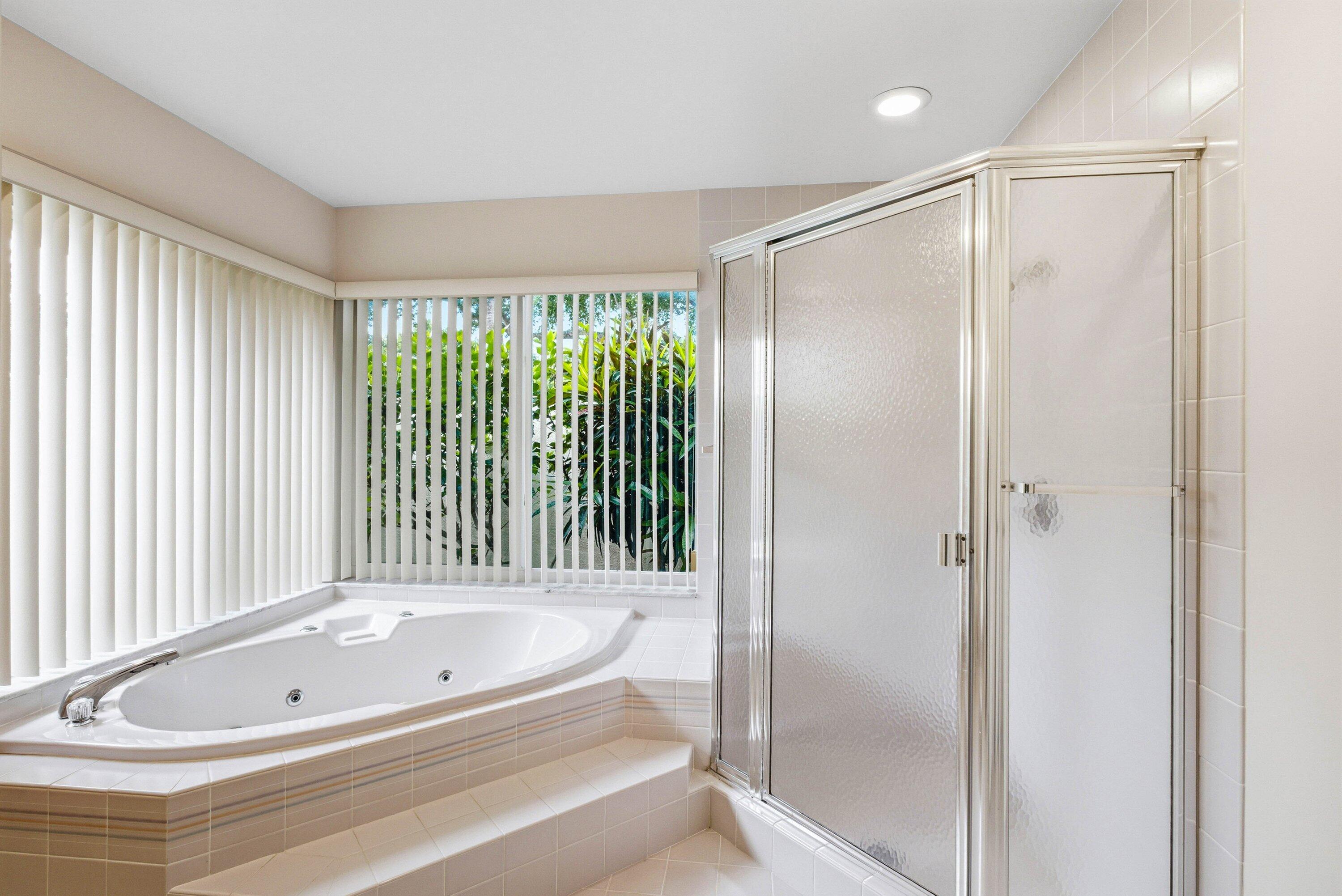 4720 Northwest 28th Avenue Boca Raton, FL 33434 - Photo 38 of 47 a bathroom with a tub and a shower
