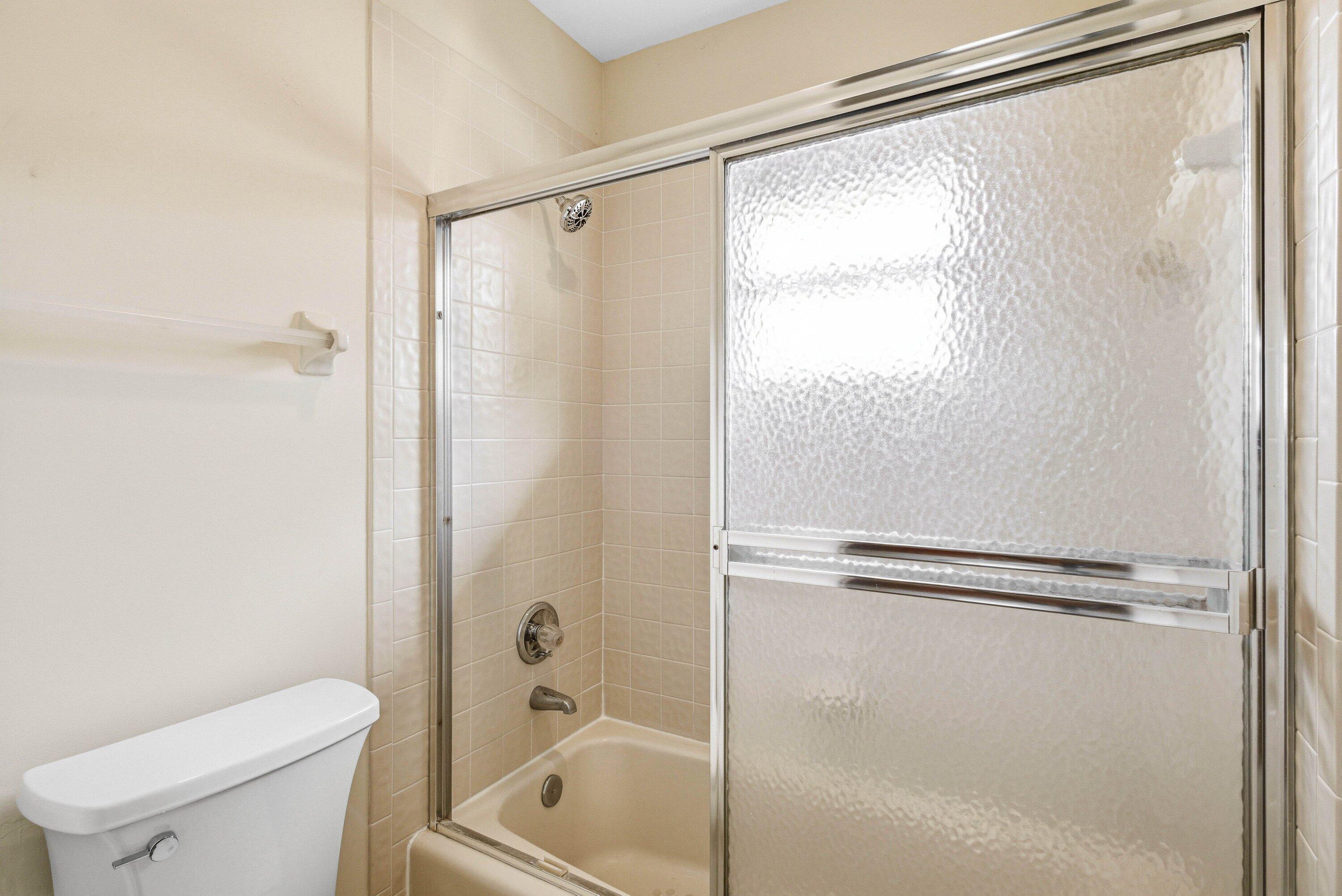 4720 Northwest 28th Avenue Boca Raton, FL 33434 - Photo 43 of 47 a bathroom with a shower and a toilet