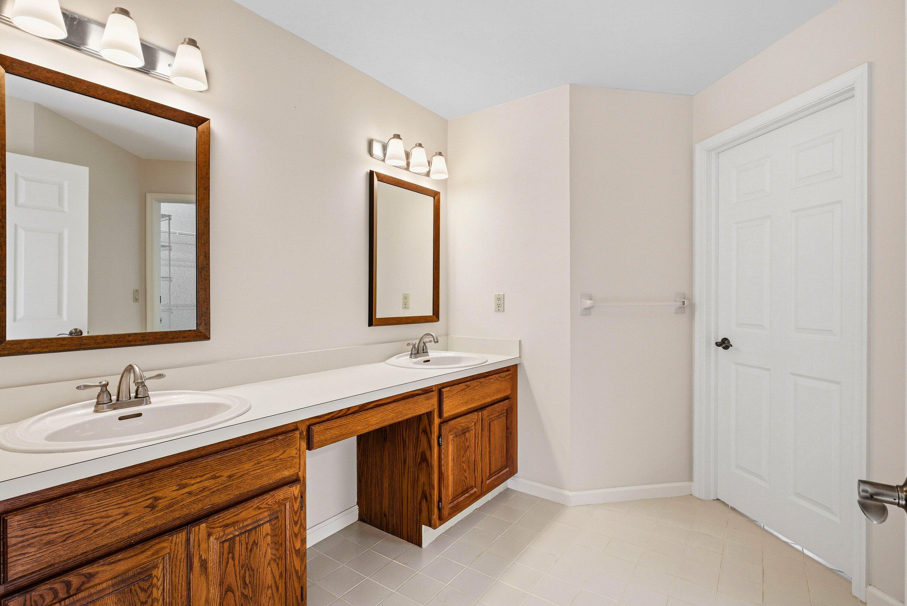 4720 Northwest 28th Avenue Boca Raton, FL 33434 - Photo 44 of 47 a spacious bathroom with a double vanity sink and a mirror