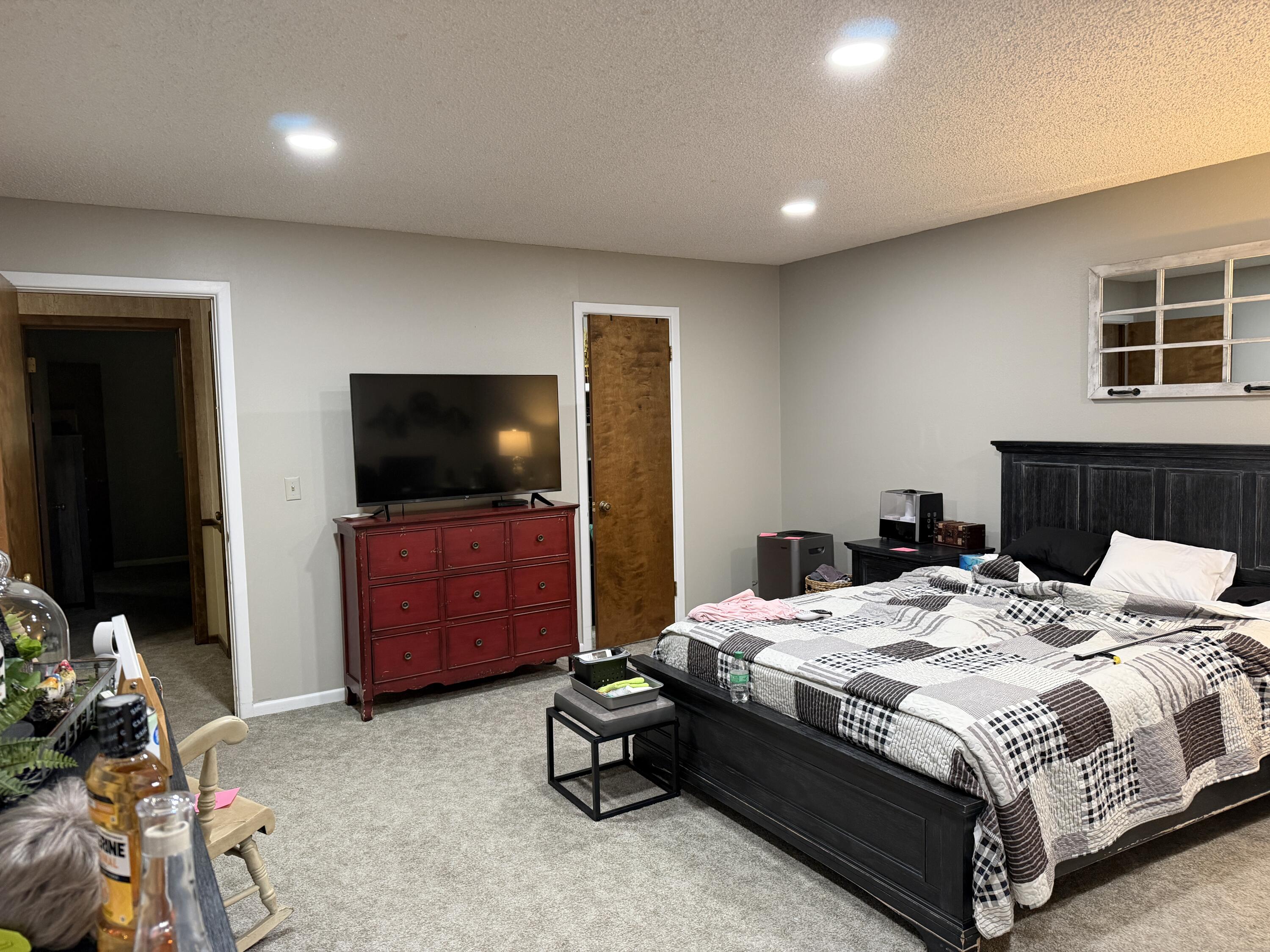 1603 South 8th Street Lamesa, TX 79331 - Photo 17 of 39 a bedroom with a bed and a flat screen tv